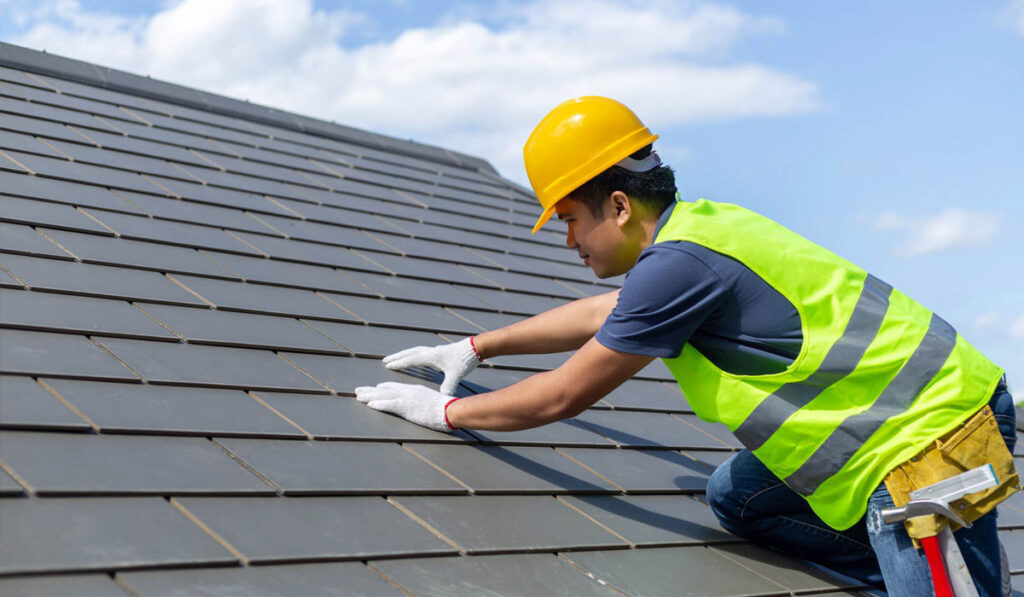 Roofer installin a new metal roof in Utah. 